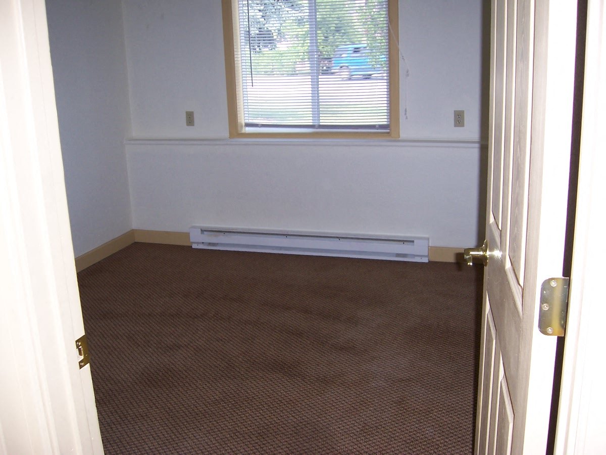Image of room with one window and one baseboard heater